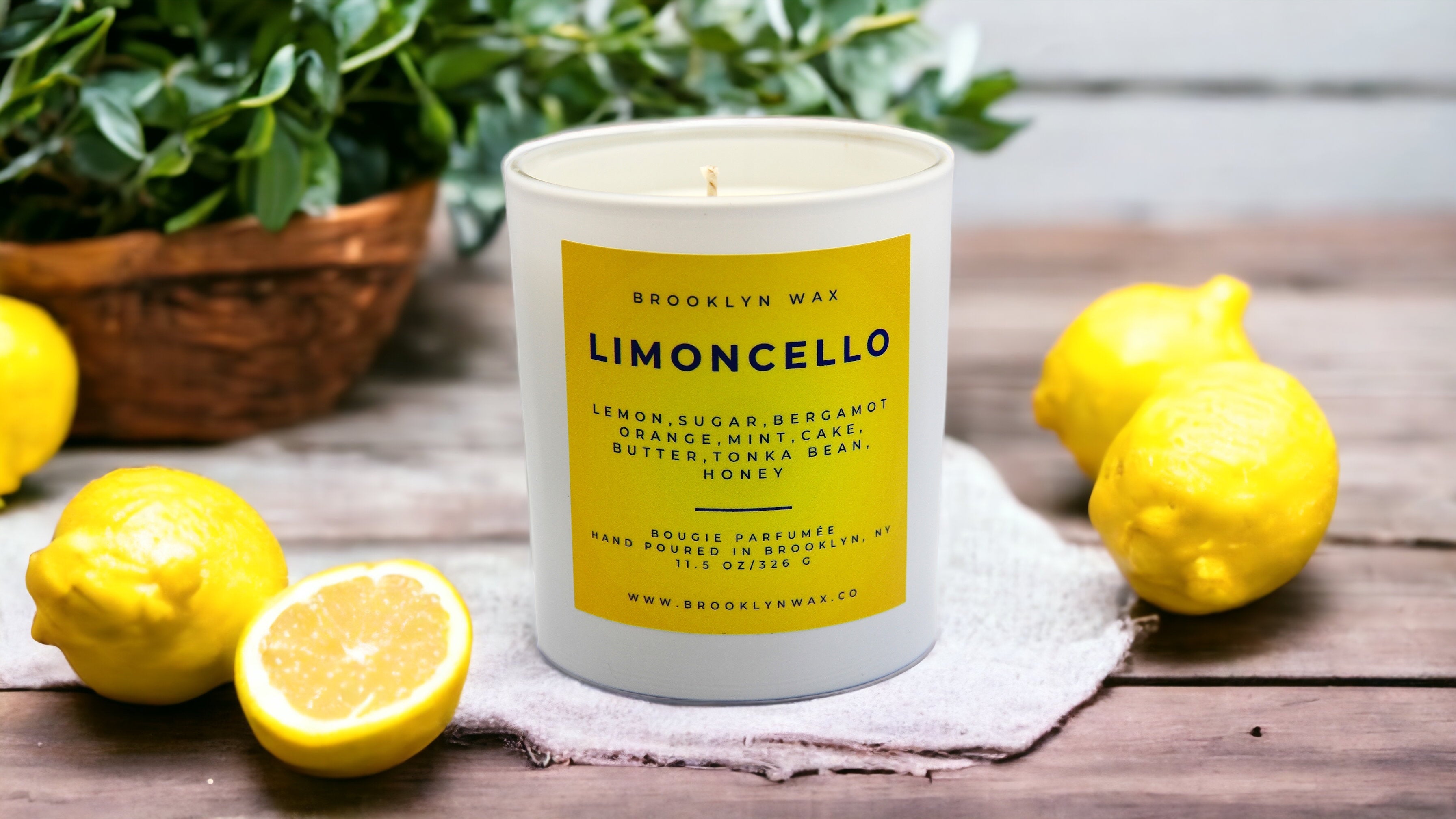 Limoncello Scented Candle on Table Surrounded by Lemons